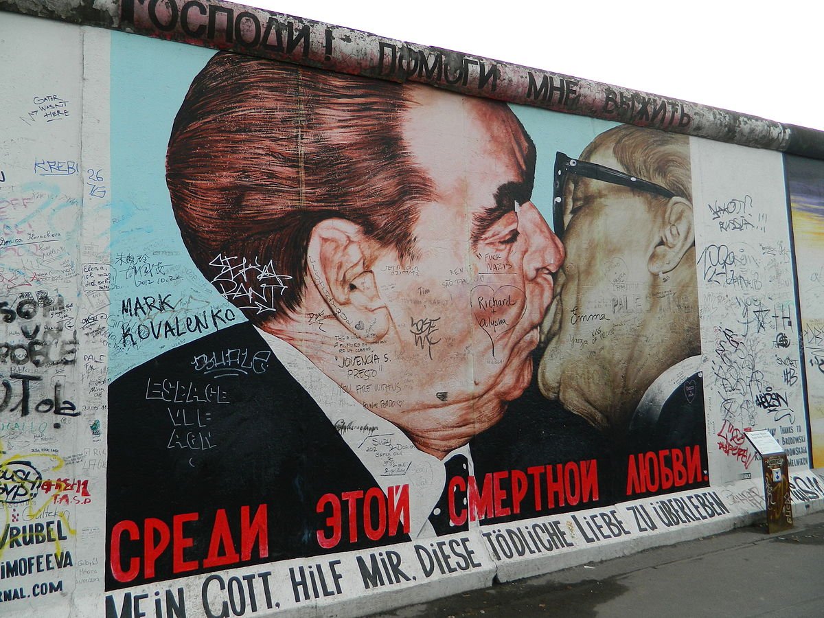 The 'Fraternal Kiss' mural, by Soviet artist Dmitri Vrubel, emblematic of the Cold War, appeared on the Berlin East Side Gallery, Berlin Wall, 1990.