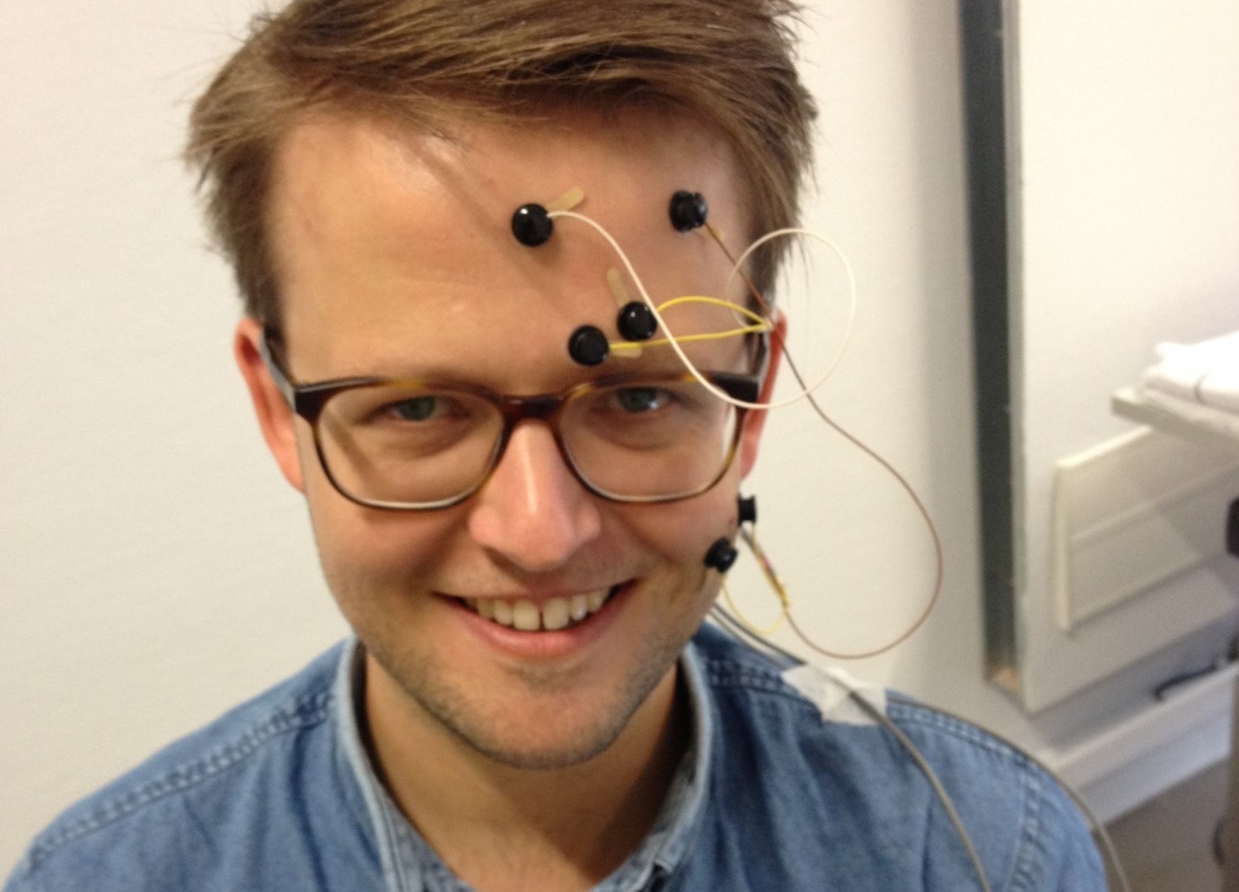 Electrodes placed over face muscles help Dr Bakker infer the feelings of test patients. Image credit — Dr Bert Bakker