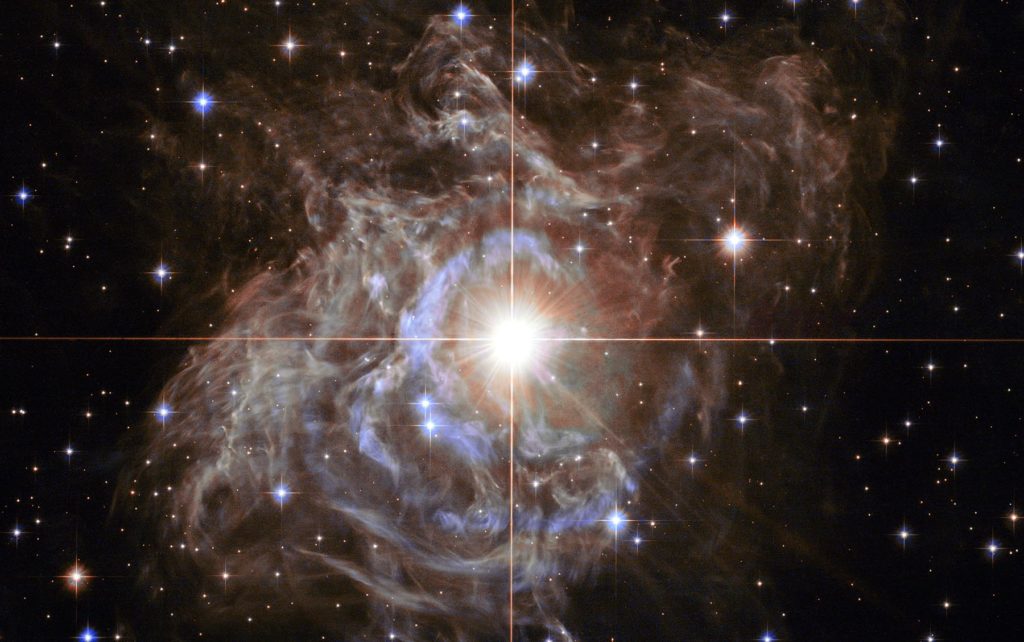 At the centre of the image is an important star called the RS Puppis, a Cepheid variable star which is a class of stars whose luminosity is used to estimate distances to nearby galaxies. This one is 15,000 times brighter than our sun.