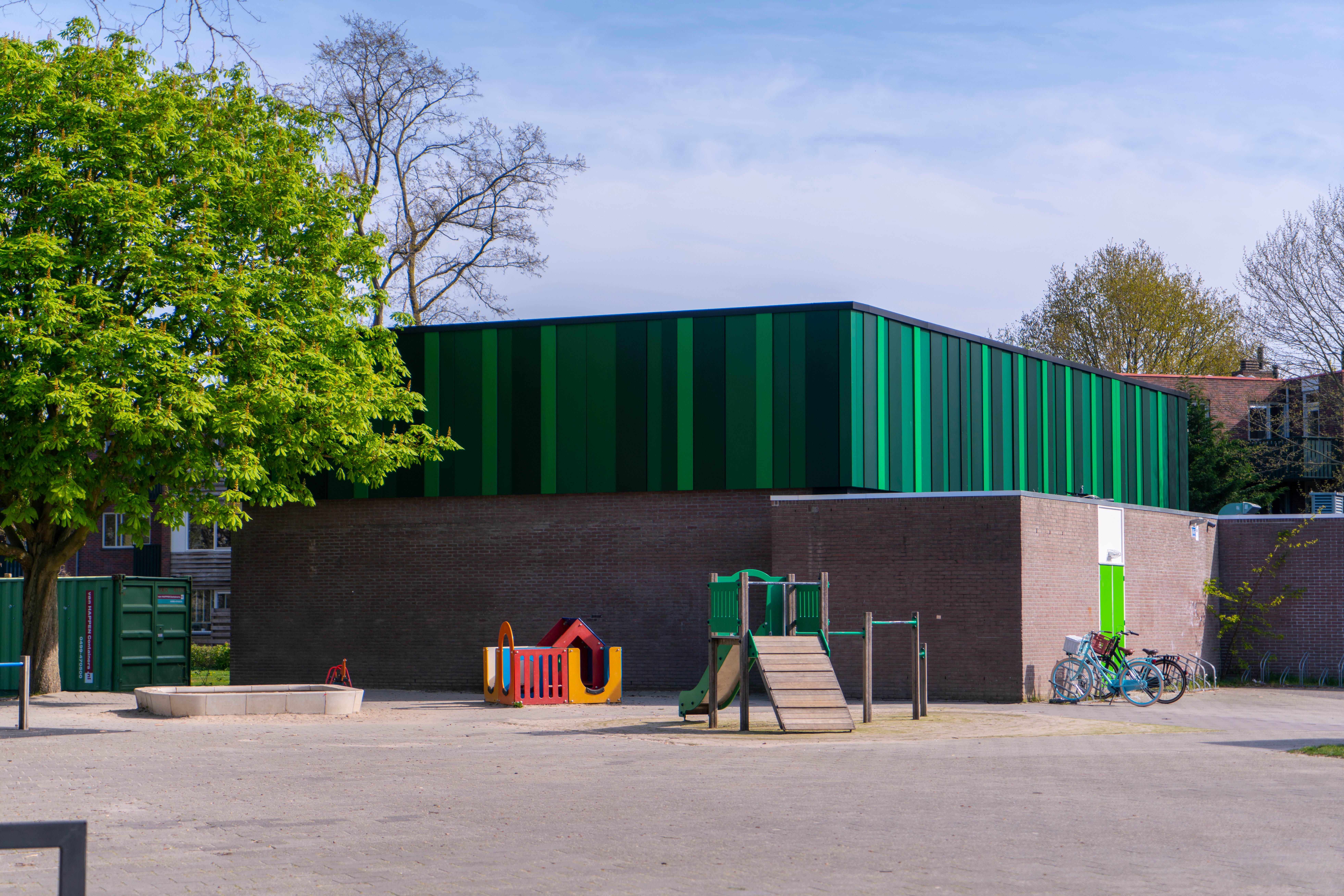 A coat of special green paint used on panels at a school gym in Almere, the Netherlands, helps the panels absorb sunlight for heating and for hot water. Image credit - Emergo
